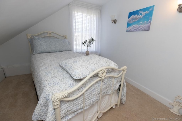 carpeted bedroom featuring lofted ceiling