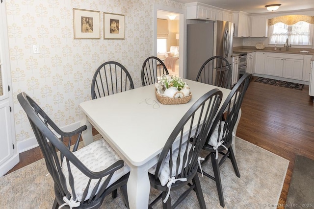 dining room with sink and dark wood-type flooring