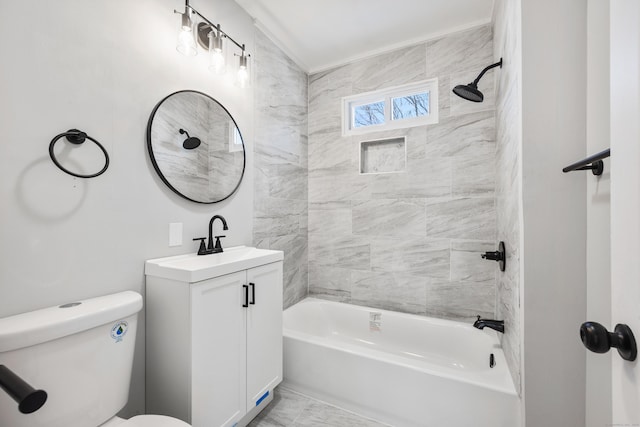 full bathroom featuring tiled shower / bath, vanity, and toilet