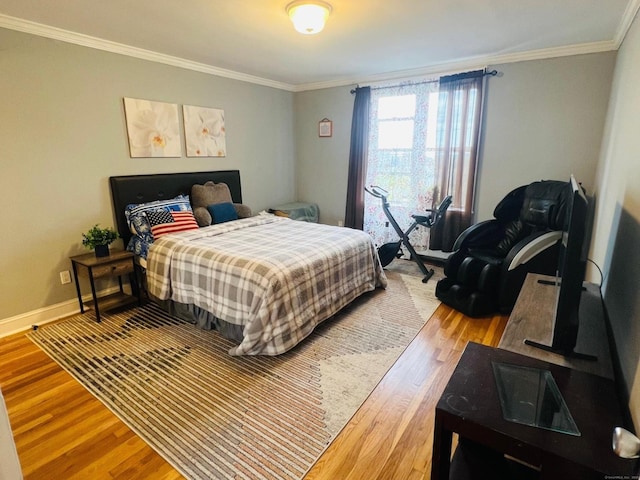 bedroom featuring wood-type flooring and crown molding