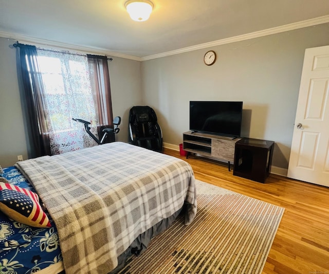 bedroom featuring crown molding and hardwood / wood-style floors