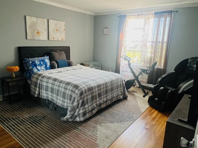 bedroom featuring hardwood / wood-style flooring and ornamental molding