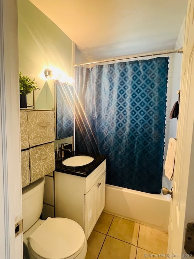 full bathroom with tile patterned floors, toilet, shower / tub combo, and vanity