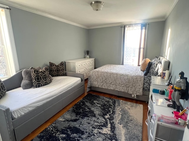 bedroom with hardwood / wood-style flooring and ornamental molding