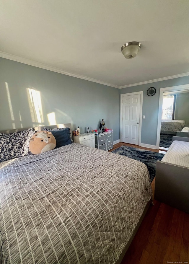 bedroom with dark hardwood / wood-style flooring and ornamental molding