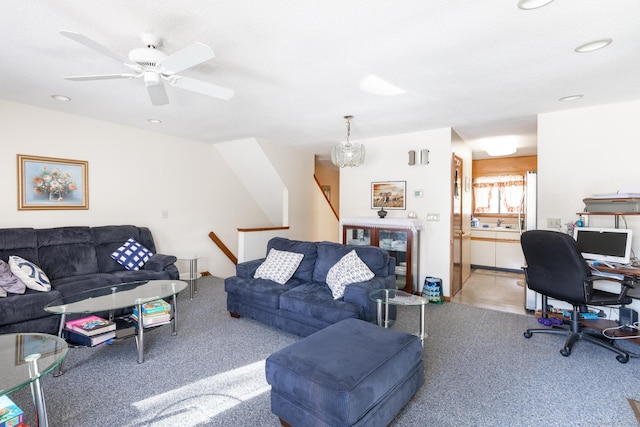 living area featuring ceiling fan with notable chandelier and recessed lighting