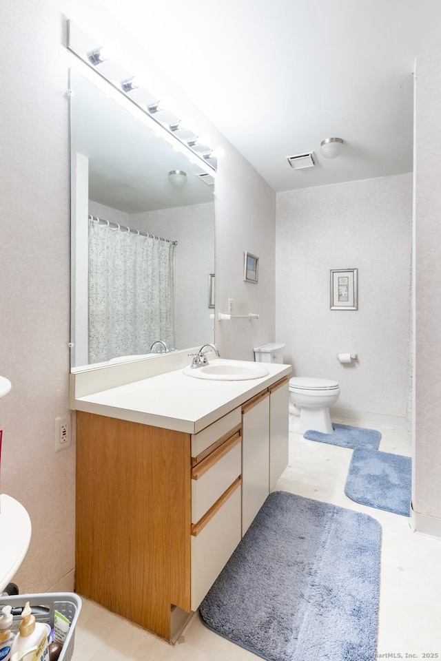 full bathroom with visible vents, vanity, and toilet