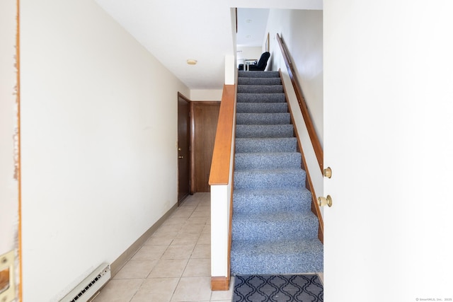 stairway featuring baseboards and tile patterned floors