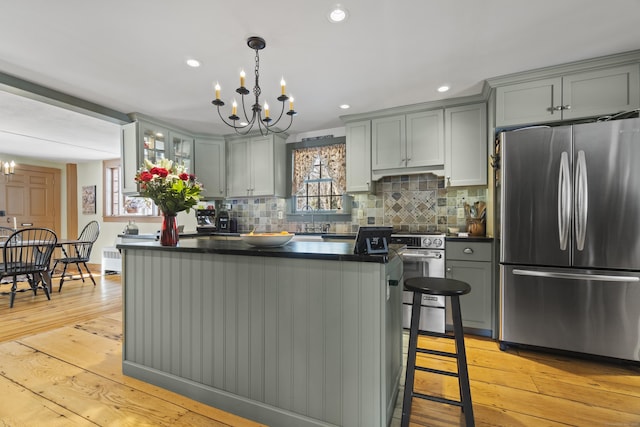 kitchen featuring tasteful backsplash, dark countertops, appliances with stainless steel finishes, and gray cabinets