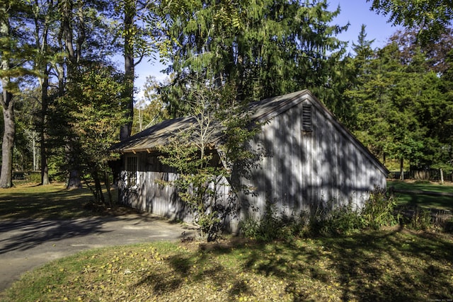 view of home's exterior featuring an outdoor structure