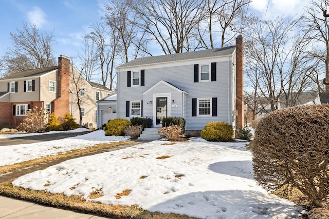 view of front of property featuring a garage and a chimney