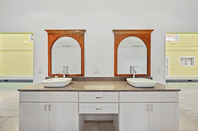 bathroom with tile patterned floors and vanity