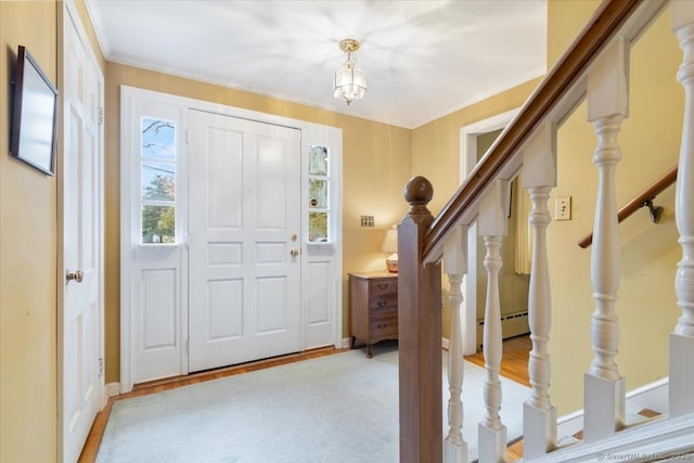 entryway featuring a baseboard radiator, light carpet, baseboards, stairway, and crown molding