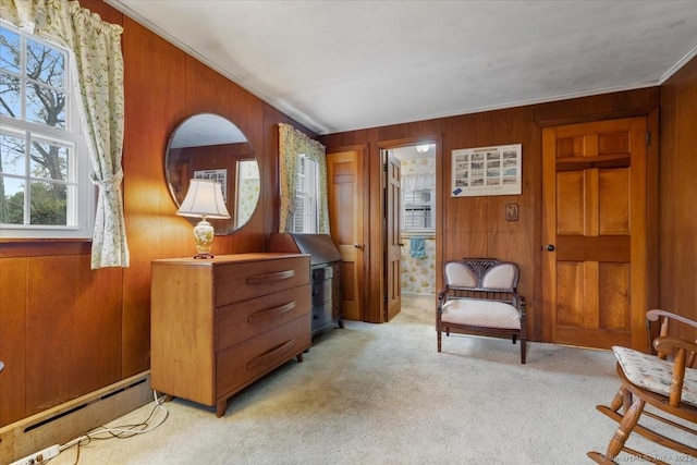 31 Pawson Rd, Branford, CT 06405 - sitting room with wood walls, a baseboard radiator, crown molding, and light colored carpet