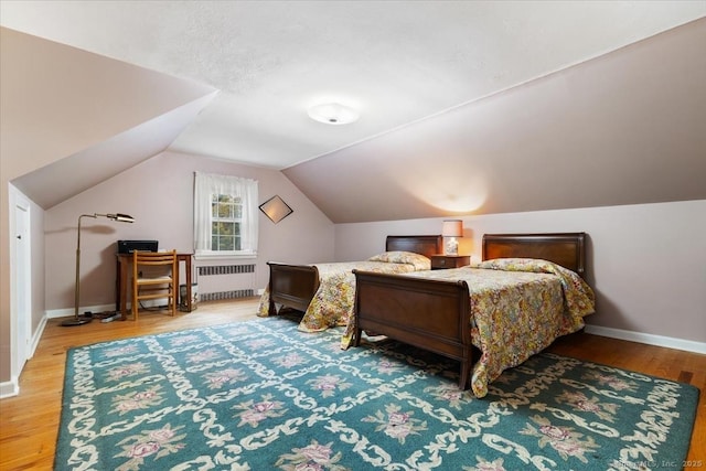 31 Pawson Rd, Branford, CT 06405 - bedroom with radiator heating unit, baseboards, vaulted ceiling, and wood finished floors