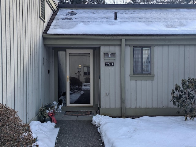 view of snow covered property entrance