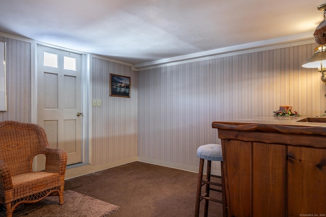 interior space featuring bar and baseboards