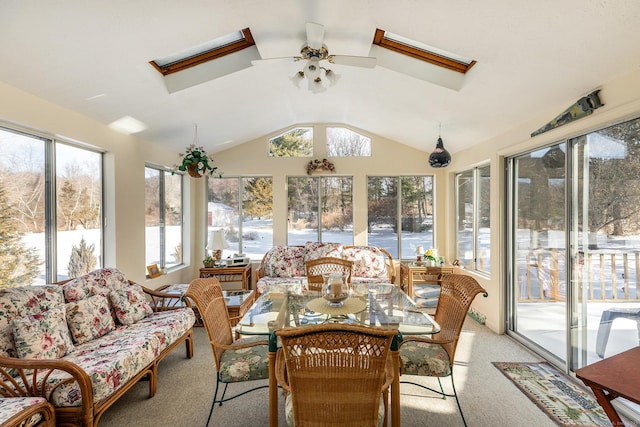 sunroom with ceiling fan and vaulted ceiling with skylight