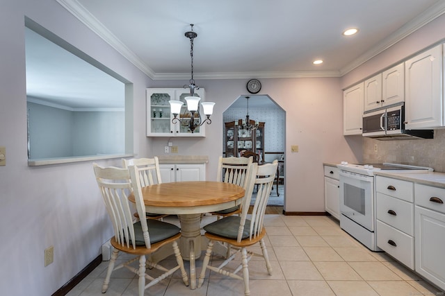 kitchen with white electric range oven, white cabinets, stainless steel microwave, light countertops, and pendant lighting