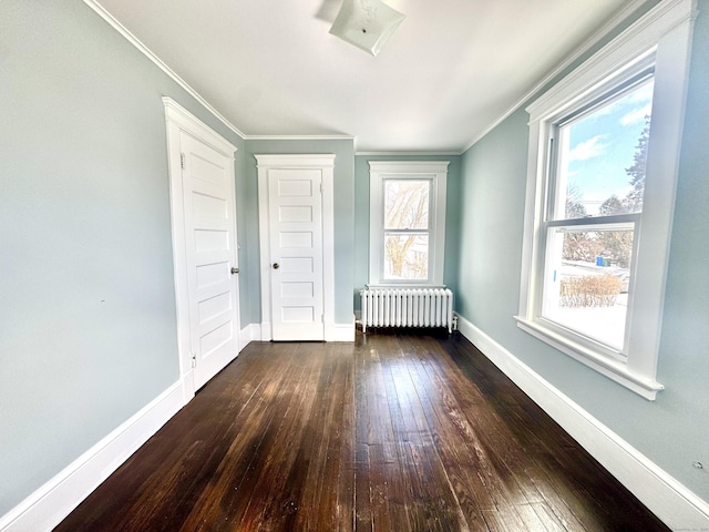 unfurnished bedroom with radiator, baseboards, dark wood-style flooring, and ornamental molding