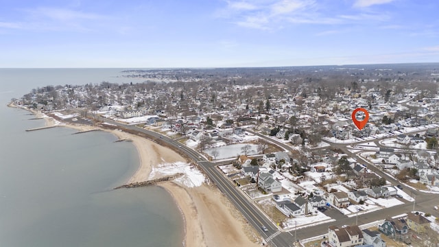 birds eye view of property featuring a water view and a beach view