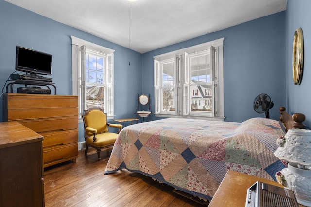 bedroom with dark wood-type flooring