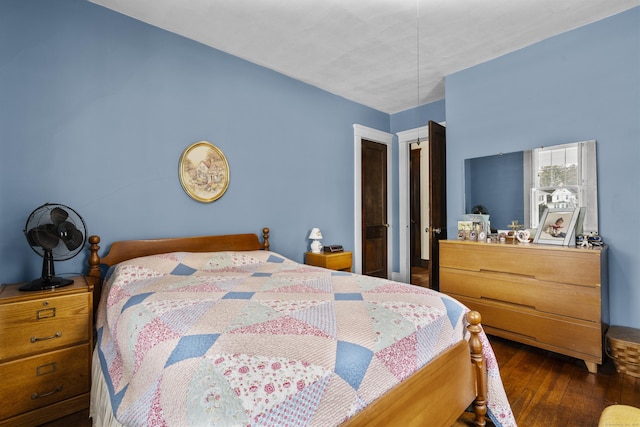 bedroom with dark wood-type flooring