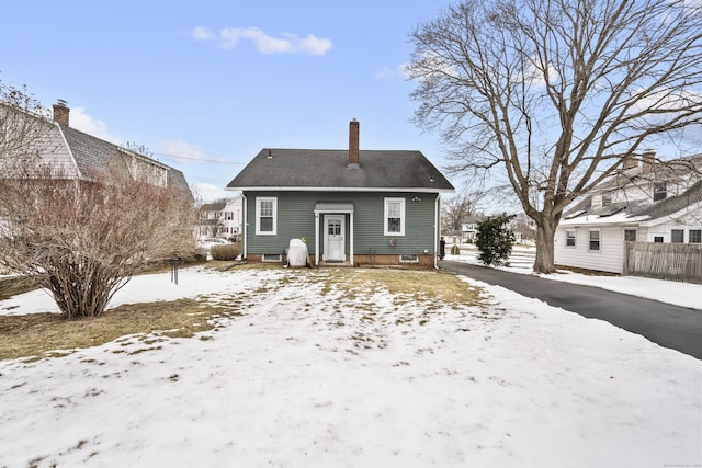 view of snow covered rear of property