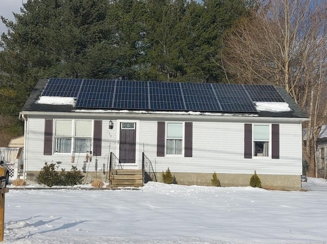 view of front of home featuring solar panels