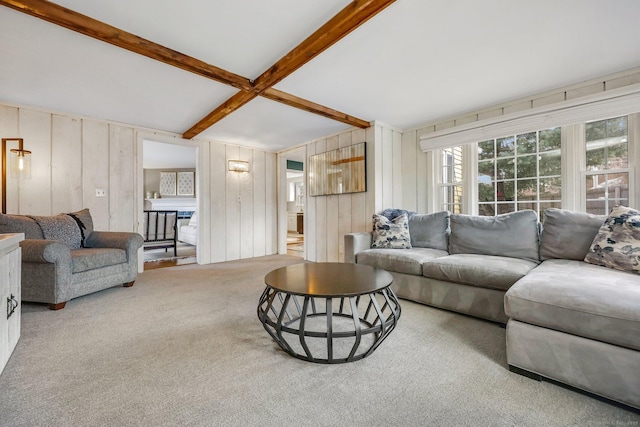 living room with beamed ceiling and carpet flooring