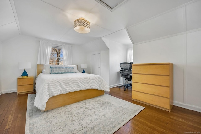 bedroom with lofted ceiling and dark wood-type flooring