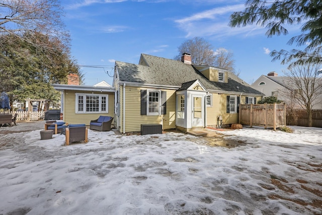 snow covered property featuring central AC