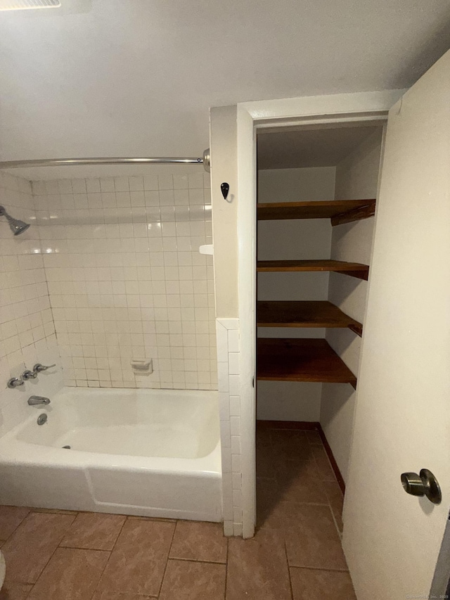 bathroom with tile patterned floors and tiled shower / bath