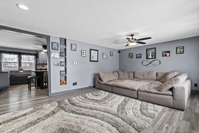 living room with dark hardwood / wood-style floors and ceiling fan