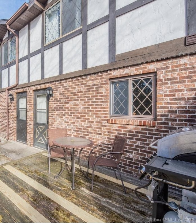 exterior space featuring brick siding and a patio area