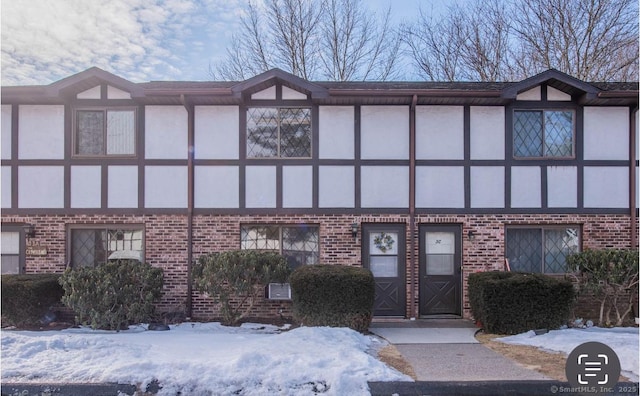 view of front of home with brick siding and stucco siding