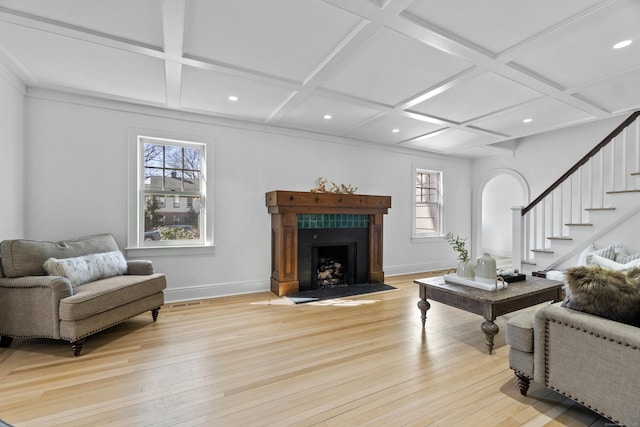 living room with light wood finished floors, baseboards, stairway, and coffered ceiling