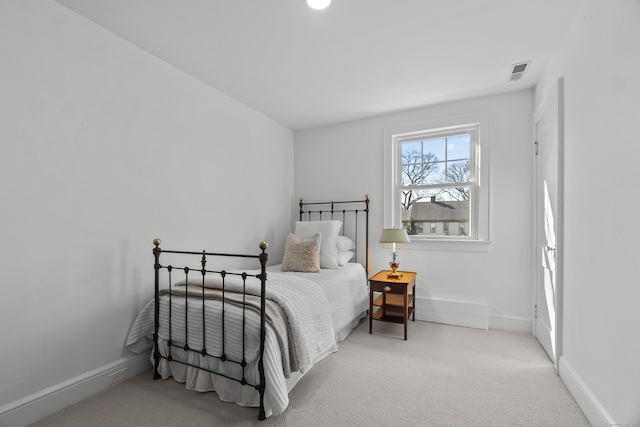 bedroom with baseboards, visible vents, and carpet flooring