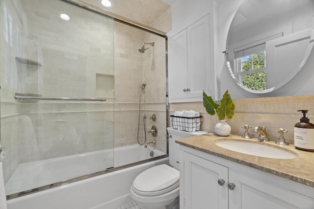 full bath featuring enclosed tub / shower combo, vanity, and toilet