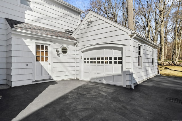 garage featuring aphalt driveway