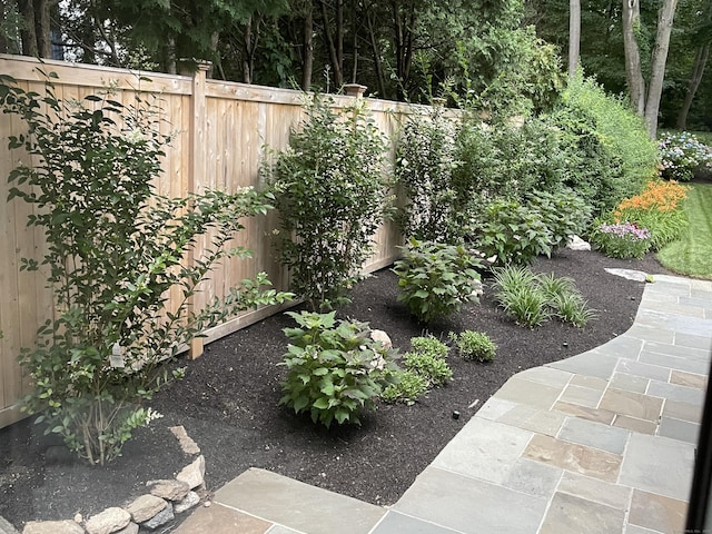 view of yard with fence and a patio