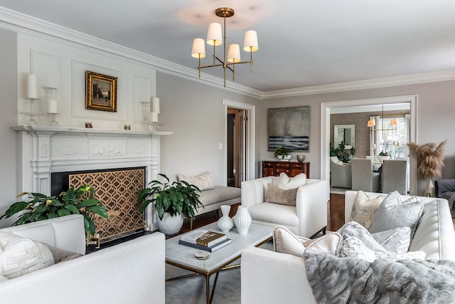 living room with crown molding, a fireplace, and a notable chandelier