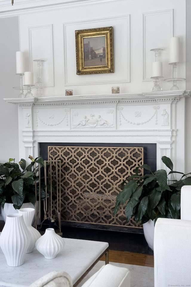 interior details featuring a fireplace and wood finished floors