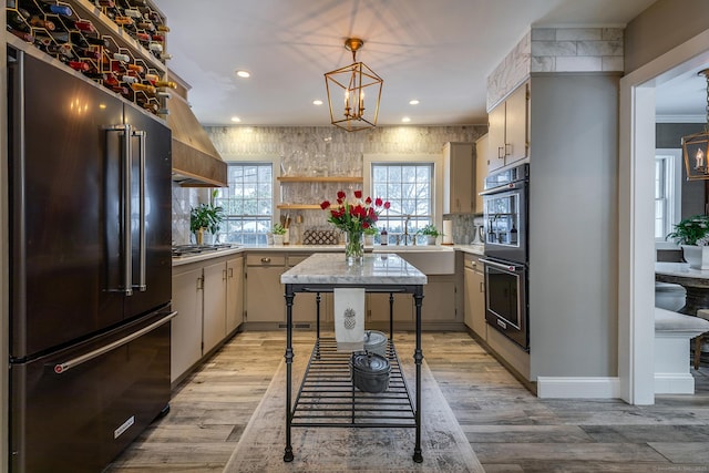 kitchen with open shelves, light countertops, multiple ovens, a chandelier, and high end refrigerator