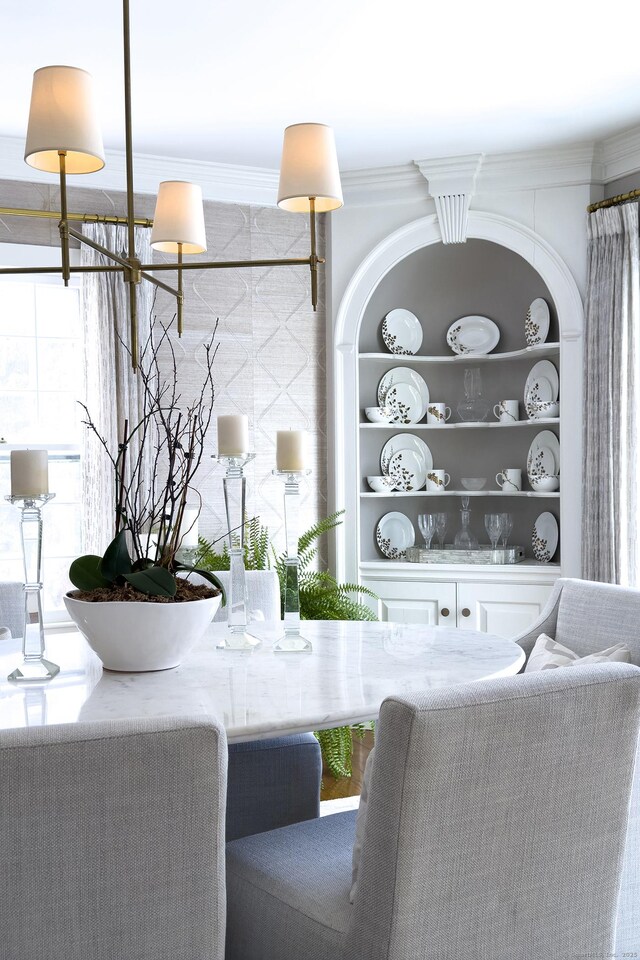 interior space featuring built in shelves and ornamental molding