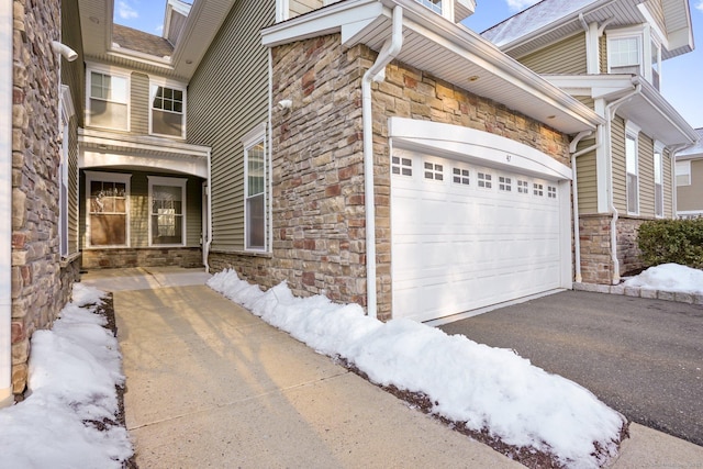 view of snow covered exterior featuring a garage