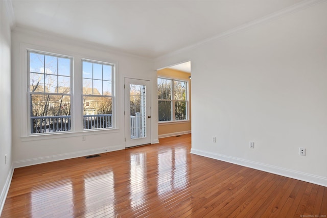 spare room with light hardwood / wood-style floors and ornamental molding