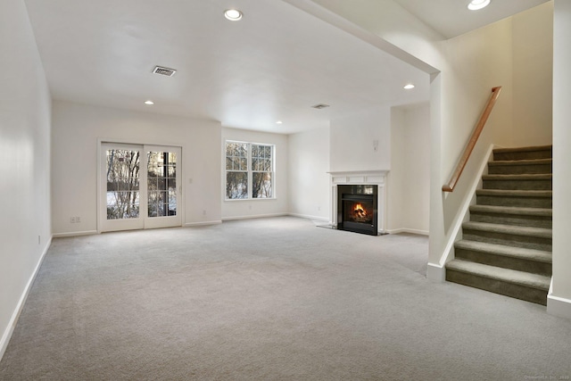 unfurnished living room featuring light colored carpet