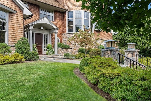 view of exterior entry featuring a yard