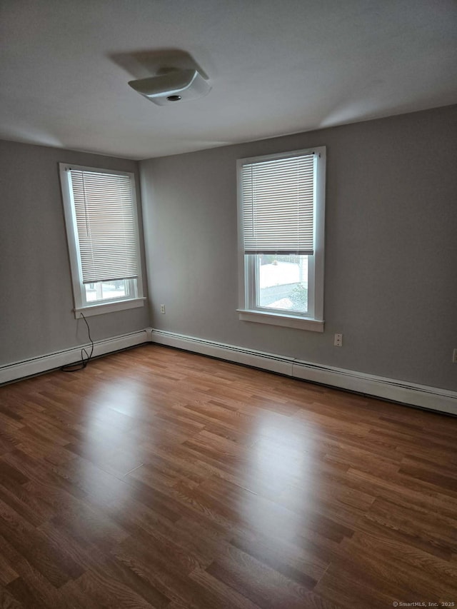 unfurnished room featuring wood finished floors and baseboards